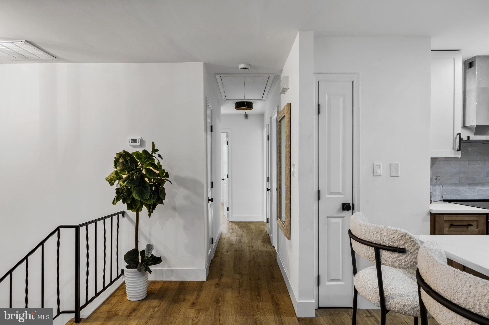 1189 Foxview Road Pottstown, PA 19465 - Photo 23 of 58 a view of a hallway with a chair and wooden floor