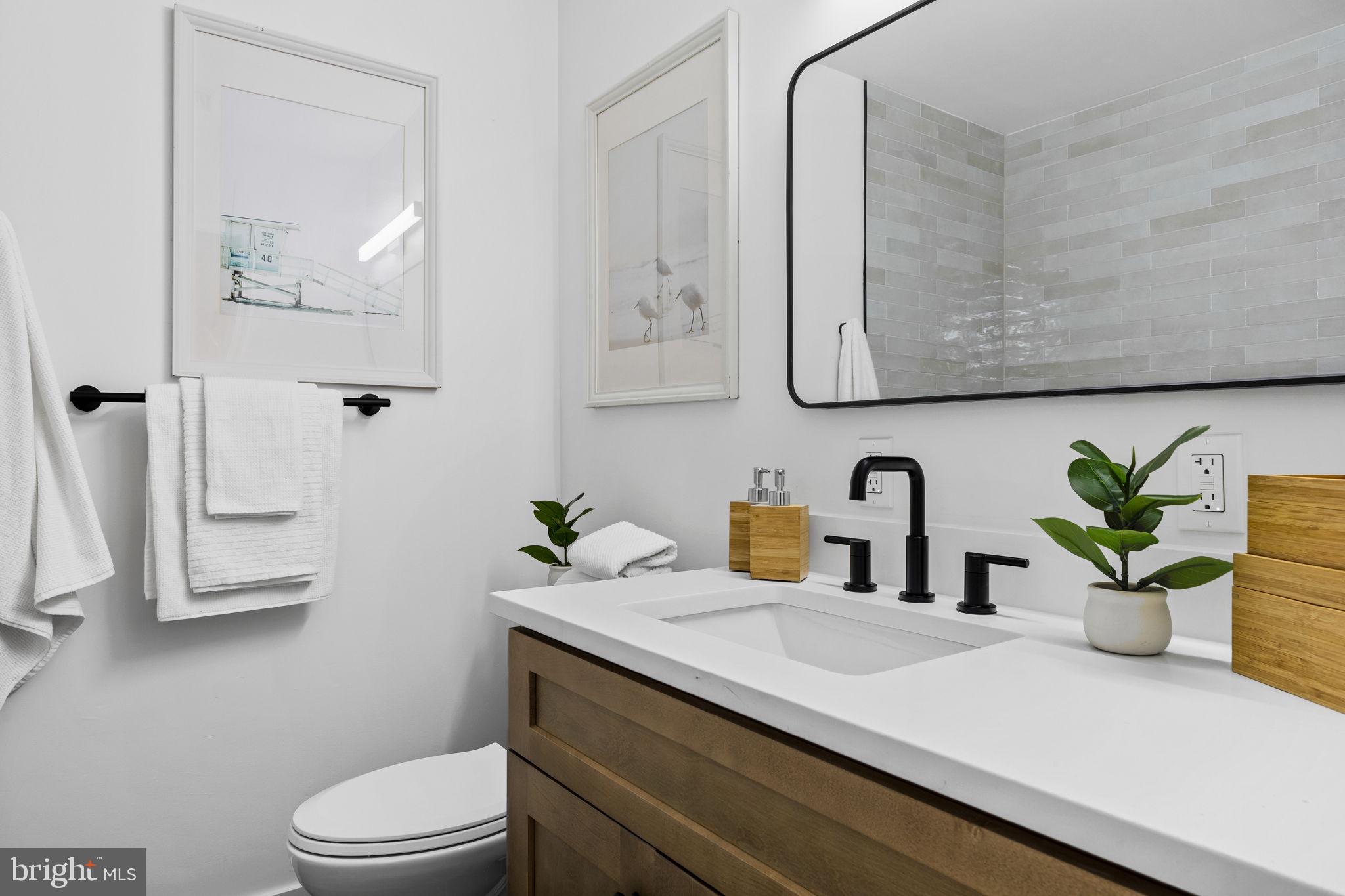 1189 Foxview Road Pottstown, PA 19465 - Photo 24 of 58 a bathroom with a granite countertop sink a toilet and mirror