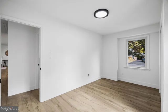 a view of an empty room and wooden floor