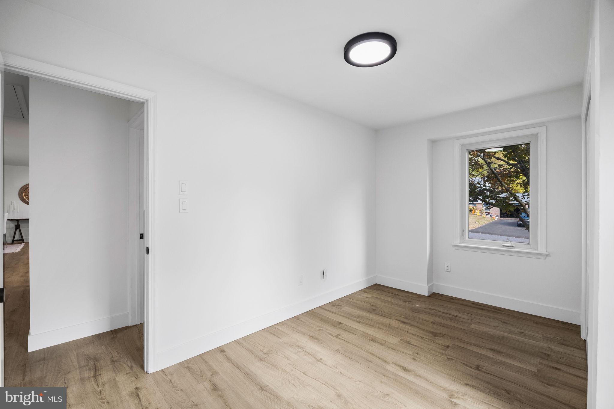1189 Foxview Road Pottstown, PA 19465 - Photo 29 of 58 an empty room with wooden floor and window