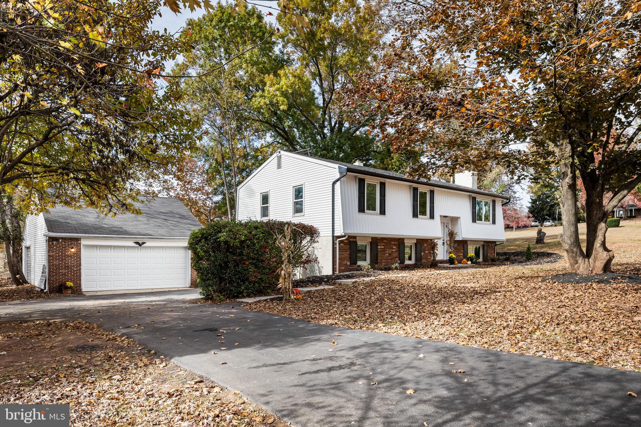 1189 Foxview Road Pottstown, PA 19465 - Photo 3 of 58 a view of a white house with a large tree in front of it