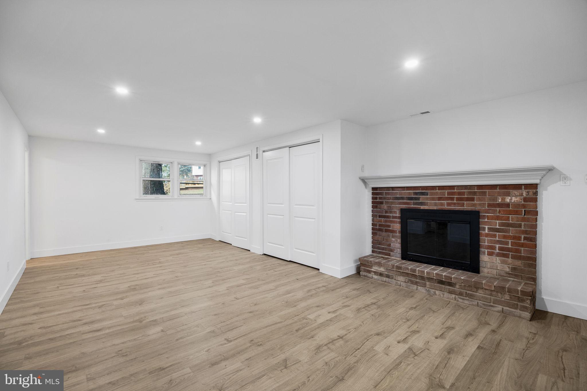 1189 Foxview Road Pottstown, PA 19465 - Photo 38 of 58 a view of an empty room with wooden floor fireplace and a window