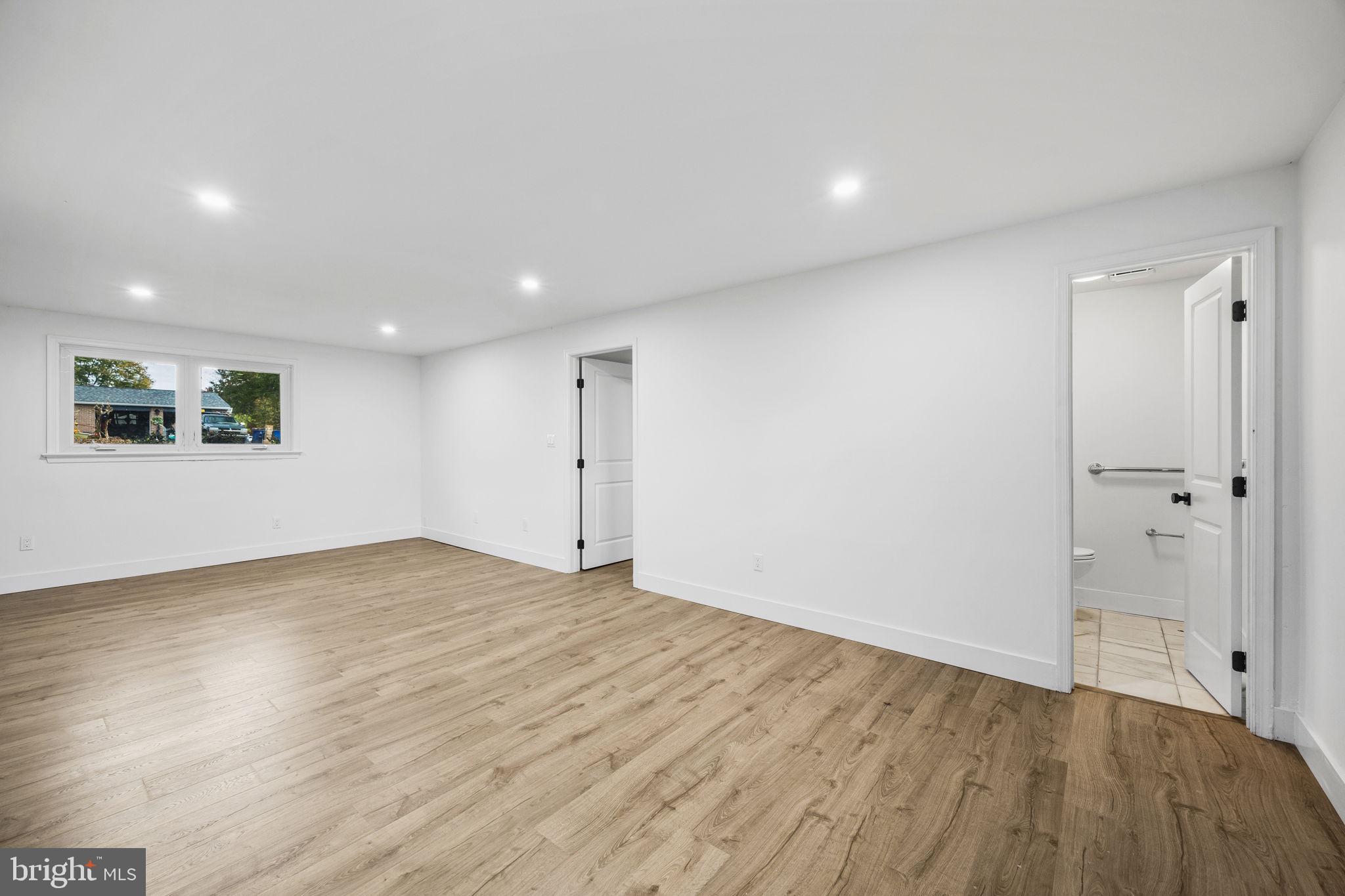 1189 Foxview Road Pottstown, PA 19465 - Photo 41 of 58 a view of an empty room with wooden floor and a window