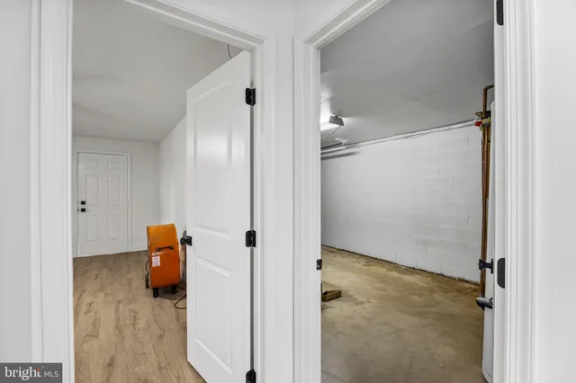 a view of a patio with a table and chairs under an umbrella