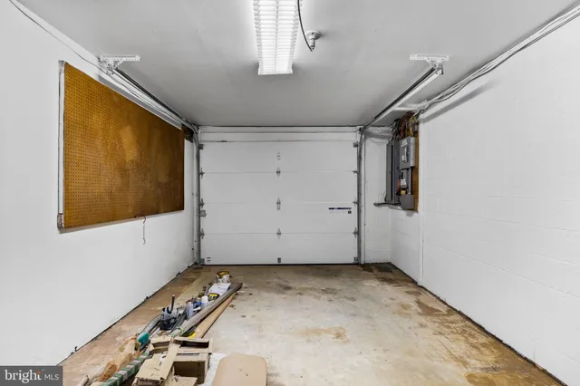 a view of a backyard with table and chairs under an umbrella