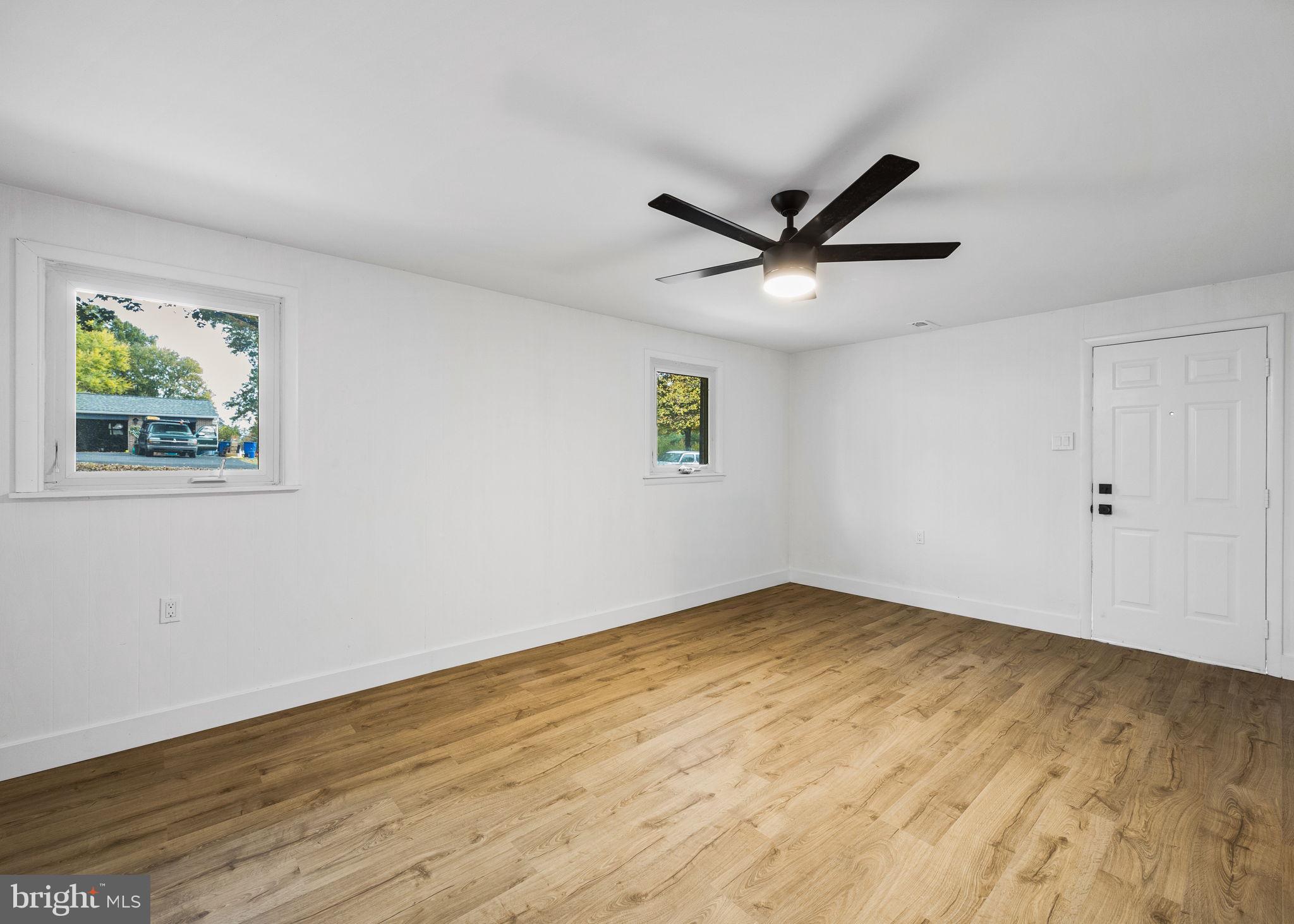 1189 Foxview Road Pottstown, PA 19465 - Photo 45 of 58 an empty room with wooden floor and ceiling fan