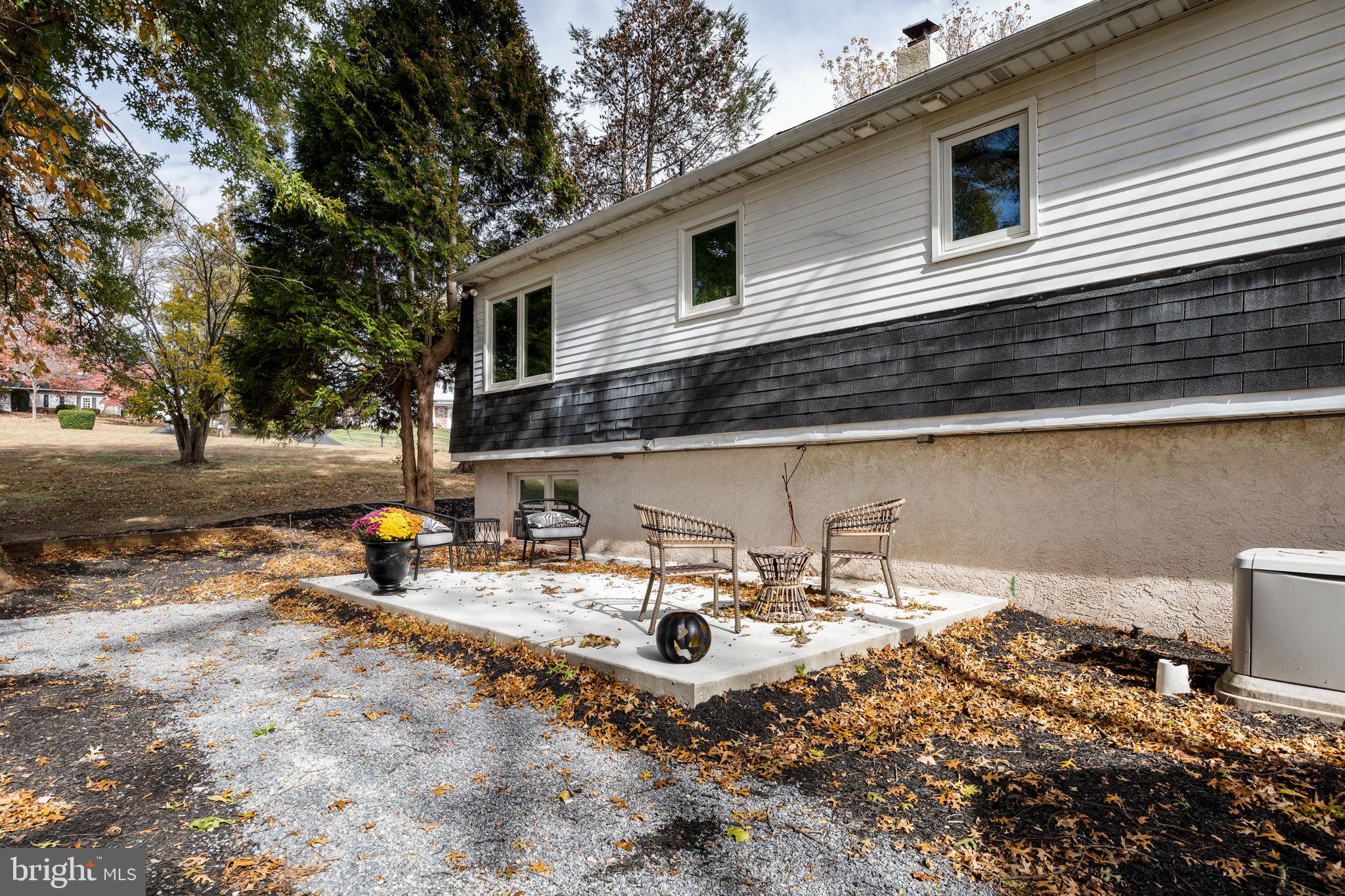 1189 Foxview Road Pottstown, PA 19465 - Photo 48 of 58 a view of a patio with a table and chairs under an umbrella