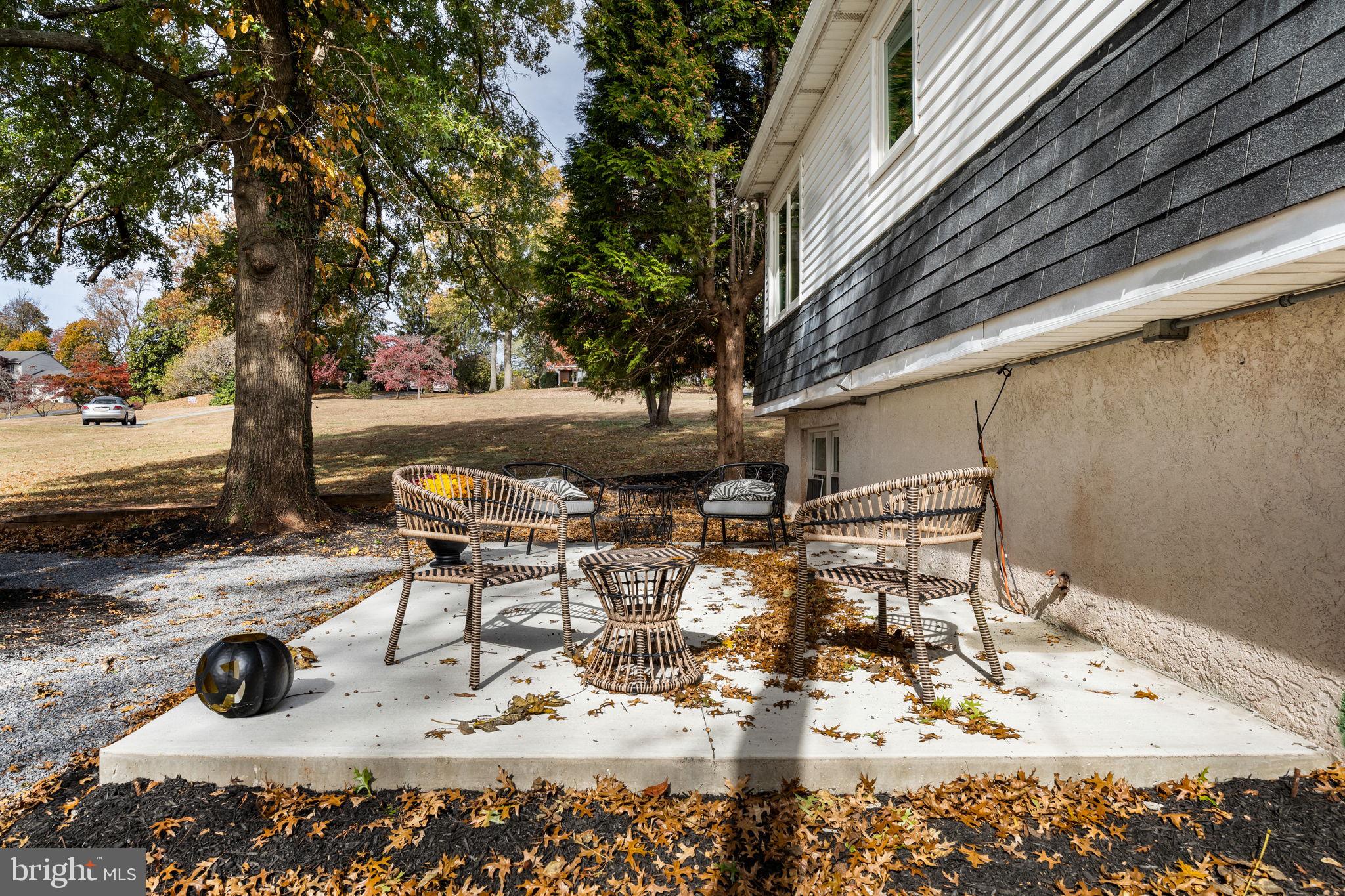 1189 Foxview Road Pottstown, PA 19465 - Photo 49 of 58 a view of a backyard with table and chairs under an umbrella