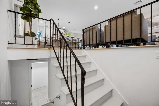 a view of staircase with wooden floor and a potted plant