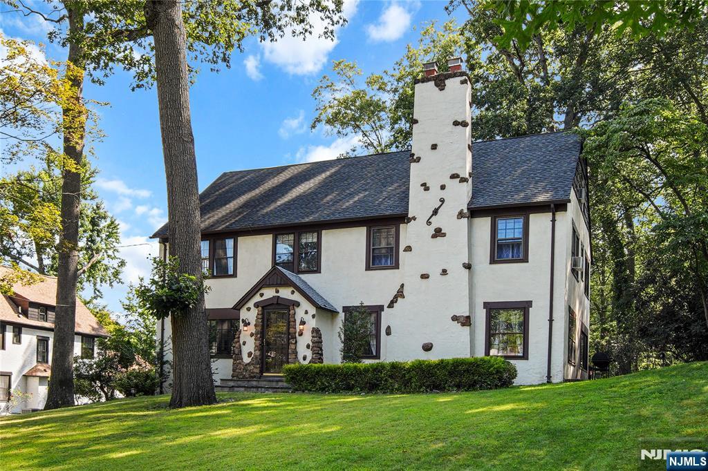 a front view of a house with a garden and plants