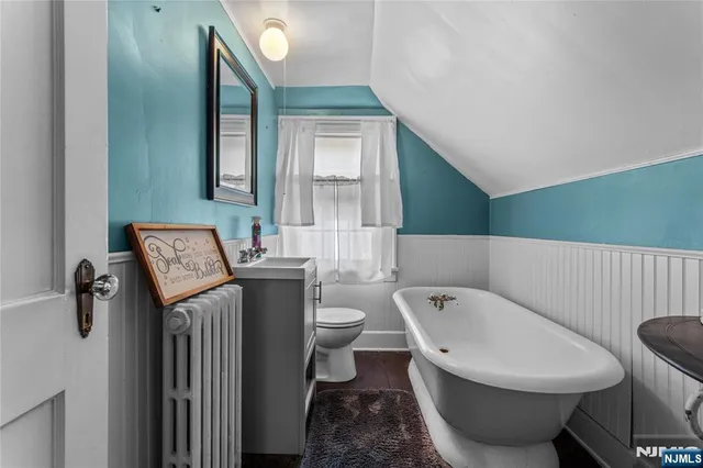 a bathroom with a toilet a sink and mirror