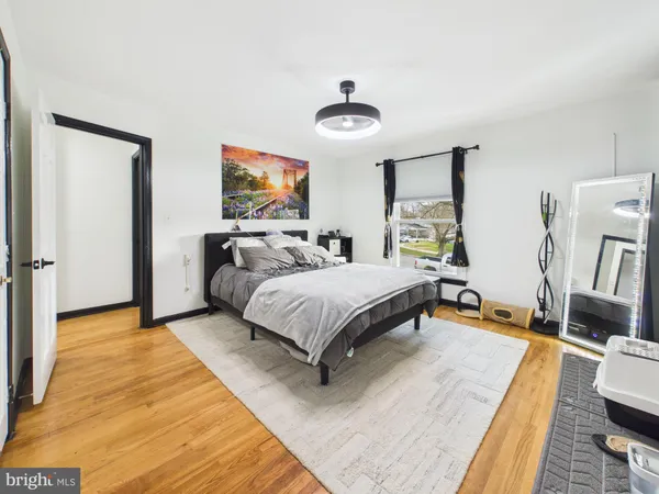a bathroom with a sink mirror toilet and next to a window