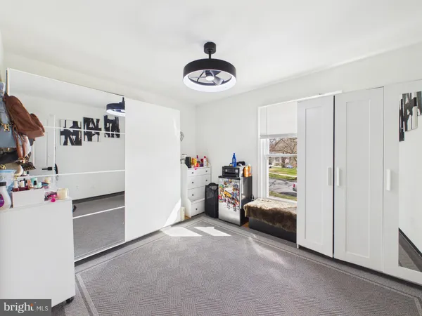 a spacious bedroom with a bed and a flat screen tv