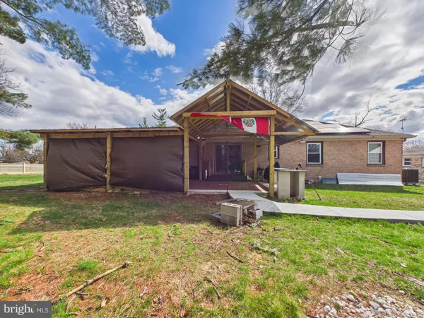 a front view of a house with a yard table and chairs