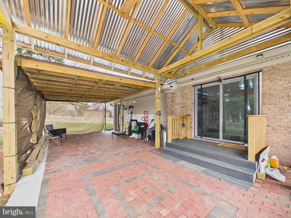 a large kitchen with stainless steel appliances kitchen island granite countertop a refrigerator and a stove top oven