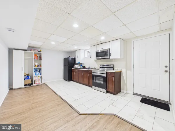 a kitchen with stainless steel appliances a refrigerator and a stove top oven