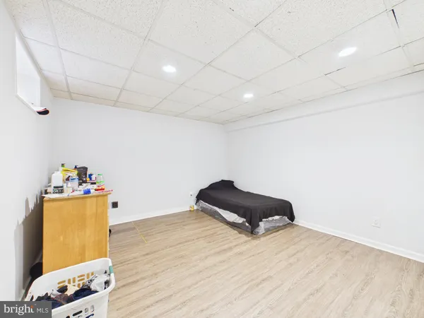 a room with a bed and a dresser