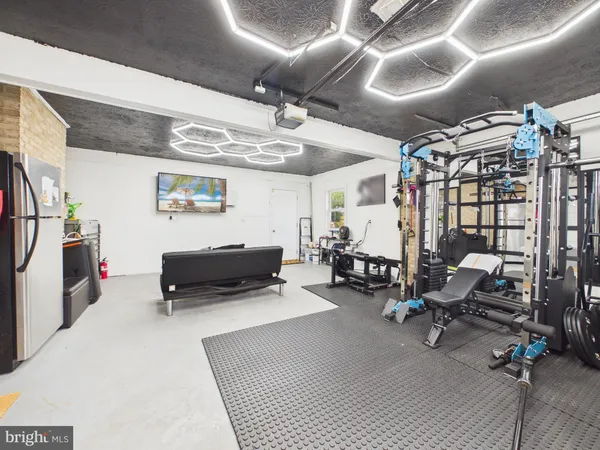 a living room with patio furniture and a fireplace