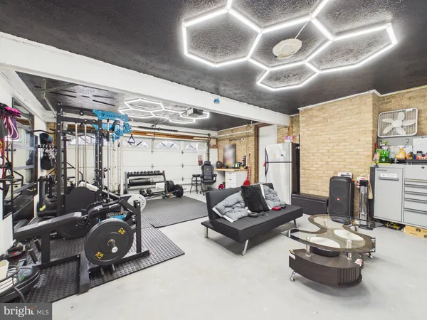 a front view of a house with a garden and trees