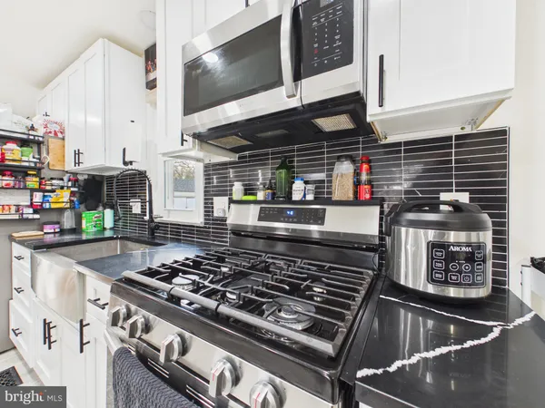 a kitchen with a stove and a microwave