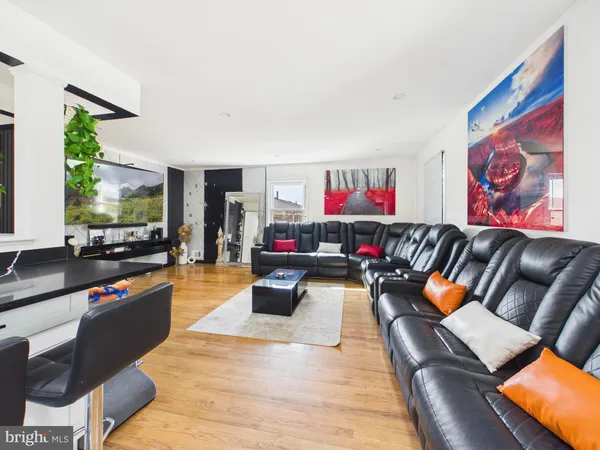 a living room with furniture and a kitchen view