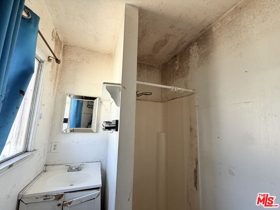 12918 Shreve Road Whittier, CA 90602 - Photo 29 of 42 a bathroom with a sink vanity granite and a mirror