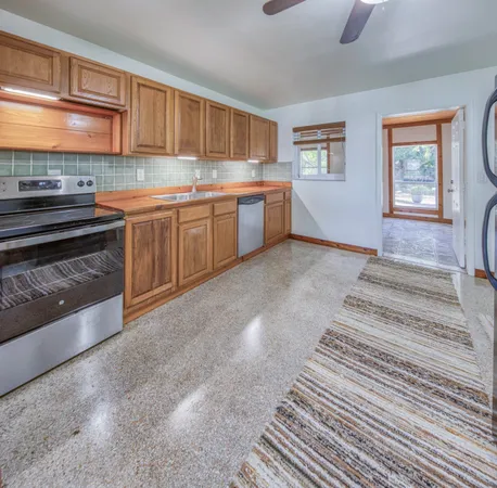 a kitchen with a stove a sink and a microwave