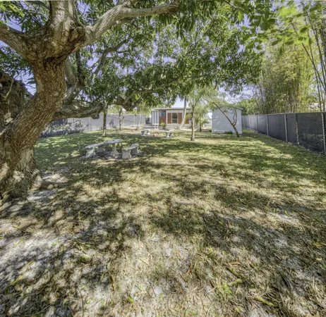 a view of a backyard with large trees
