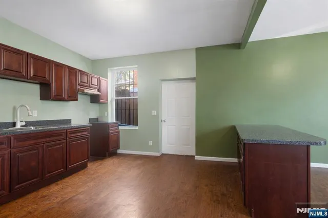 a kitchen with sink and cabinets