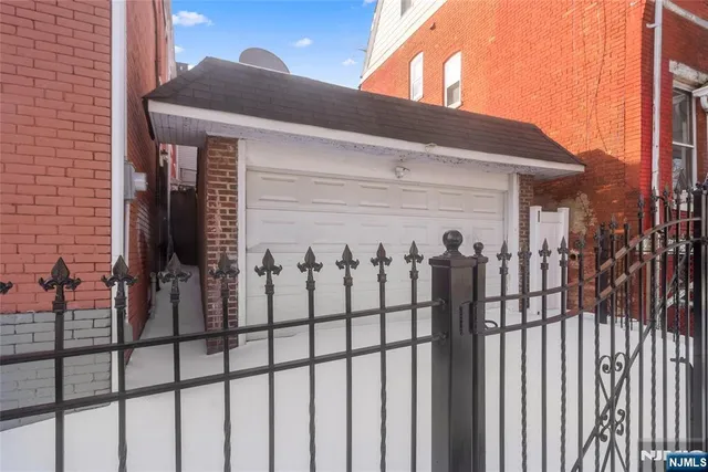 a view of a house with a wooden fence