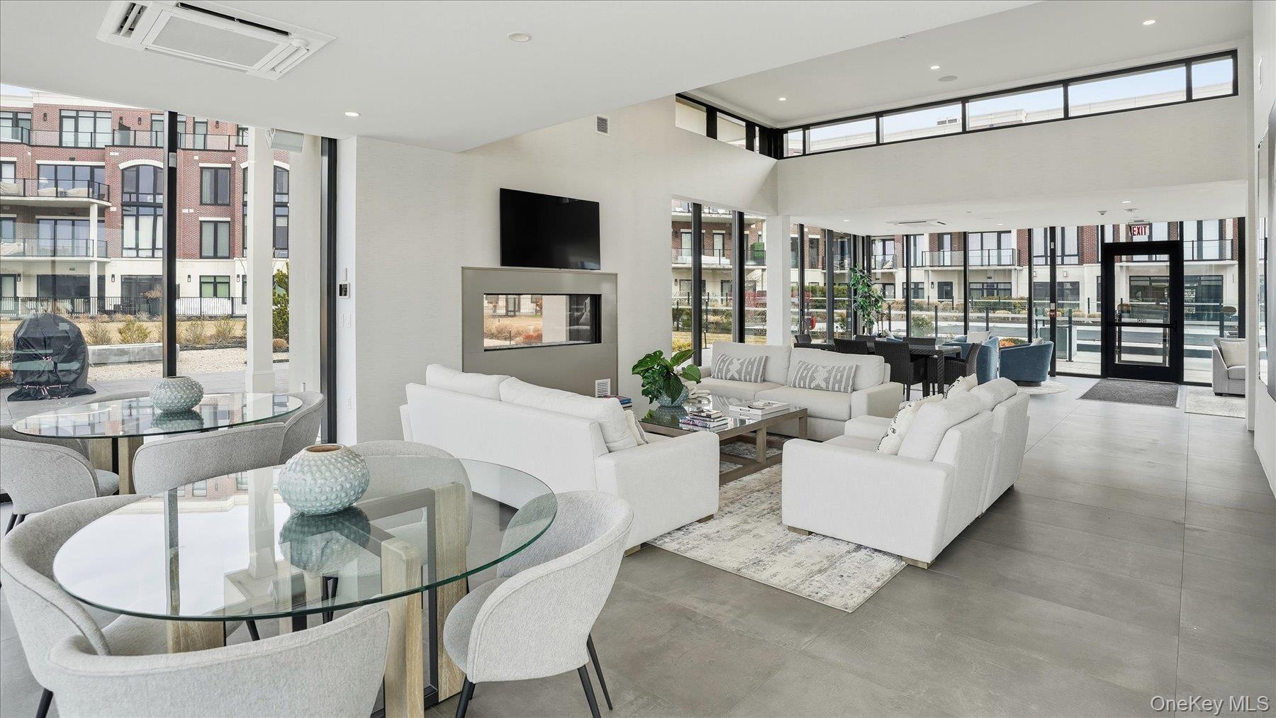 10 Shore Road, Unit 108 Glenwood Landing, NY 11547 - Photo 19 of 20 a living room with furniture and a flat screen tv