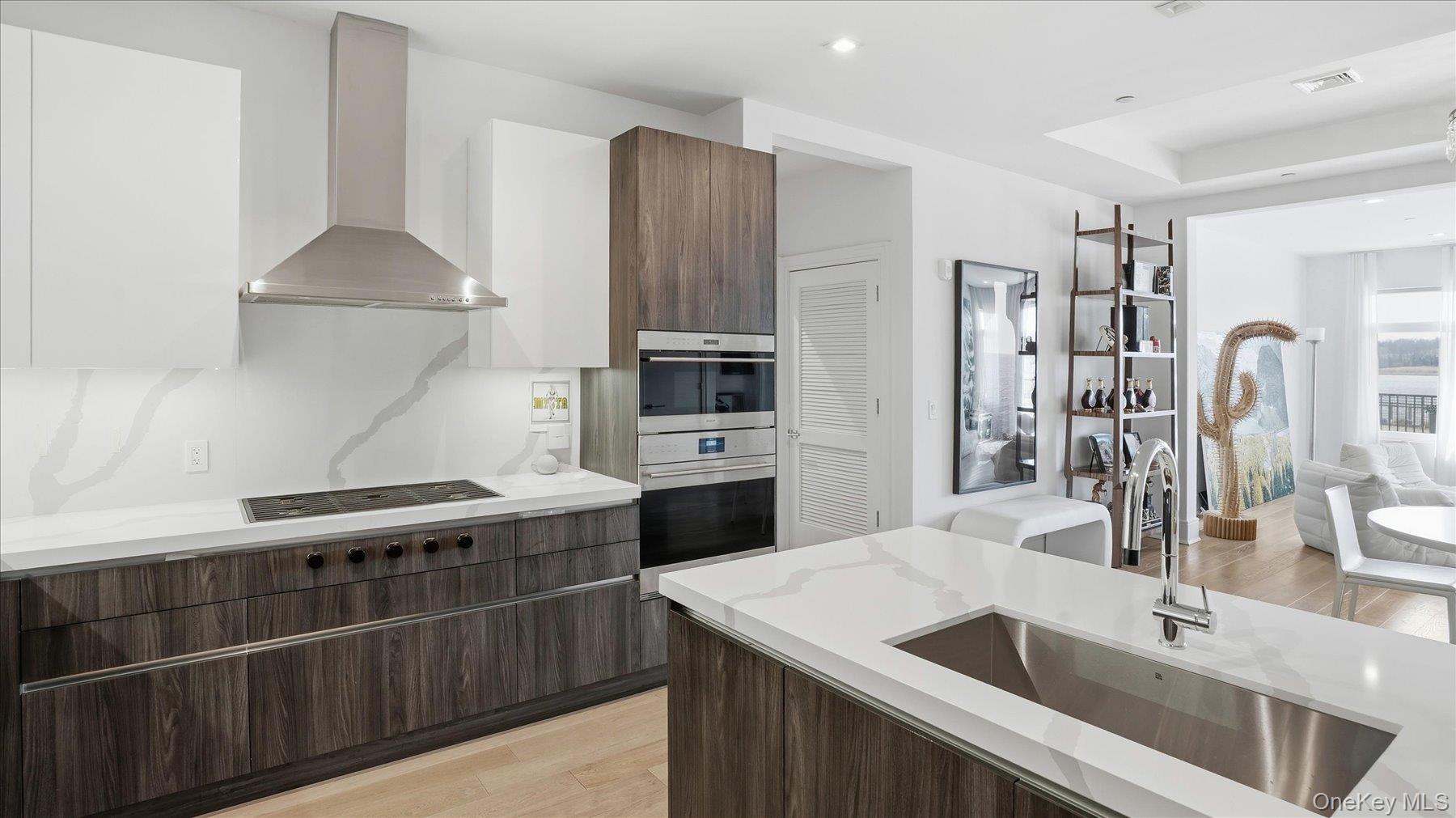 10 Shore Road, Unit 108 Glenwood Landing, NY 11547 - Photo 6 of 20 a kitchen with stainless steel appliances a sink and a refrigerator