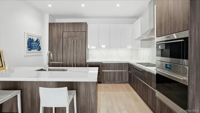 a kitchen with a sink appliances and cabinets