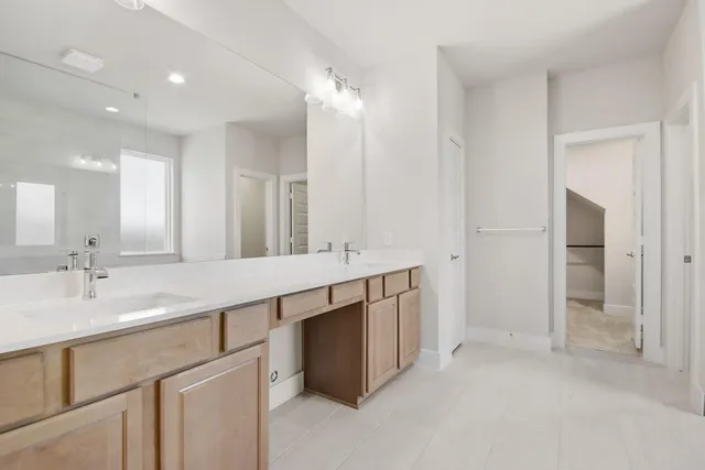 a bathroom with a double vanity sink and a mirror