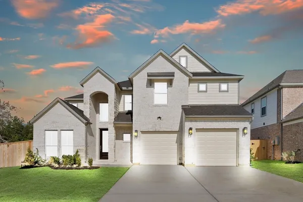 a front view of a house with a yard and garage
