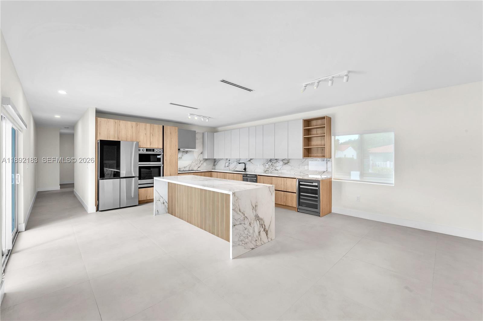 1200 Southwest 23rd Court Miami, FL 33135 - Photo 13 of 36 a large white kitchen with stainless steel appliances granite countertop a large counter top and a stove