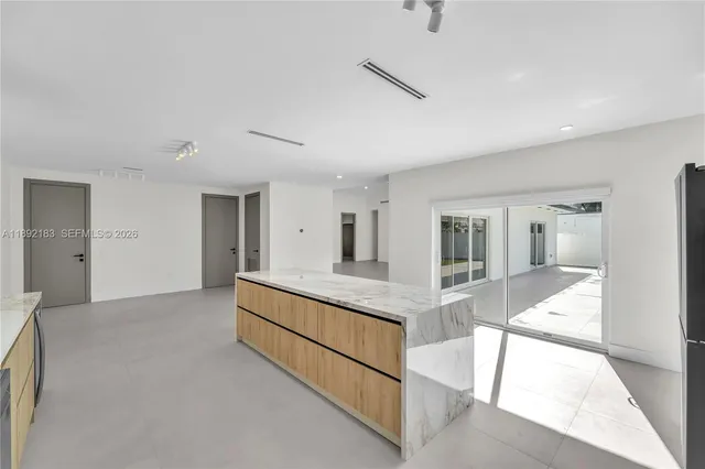 a large white room with a large mirror vanity and sink