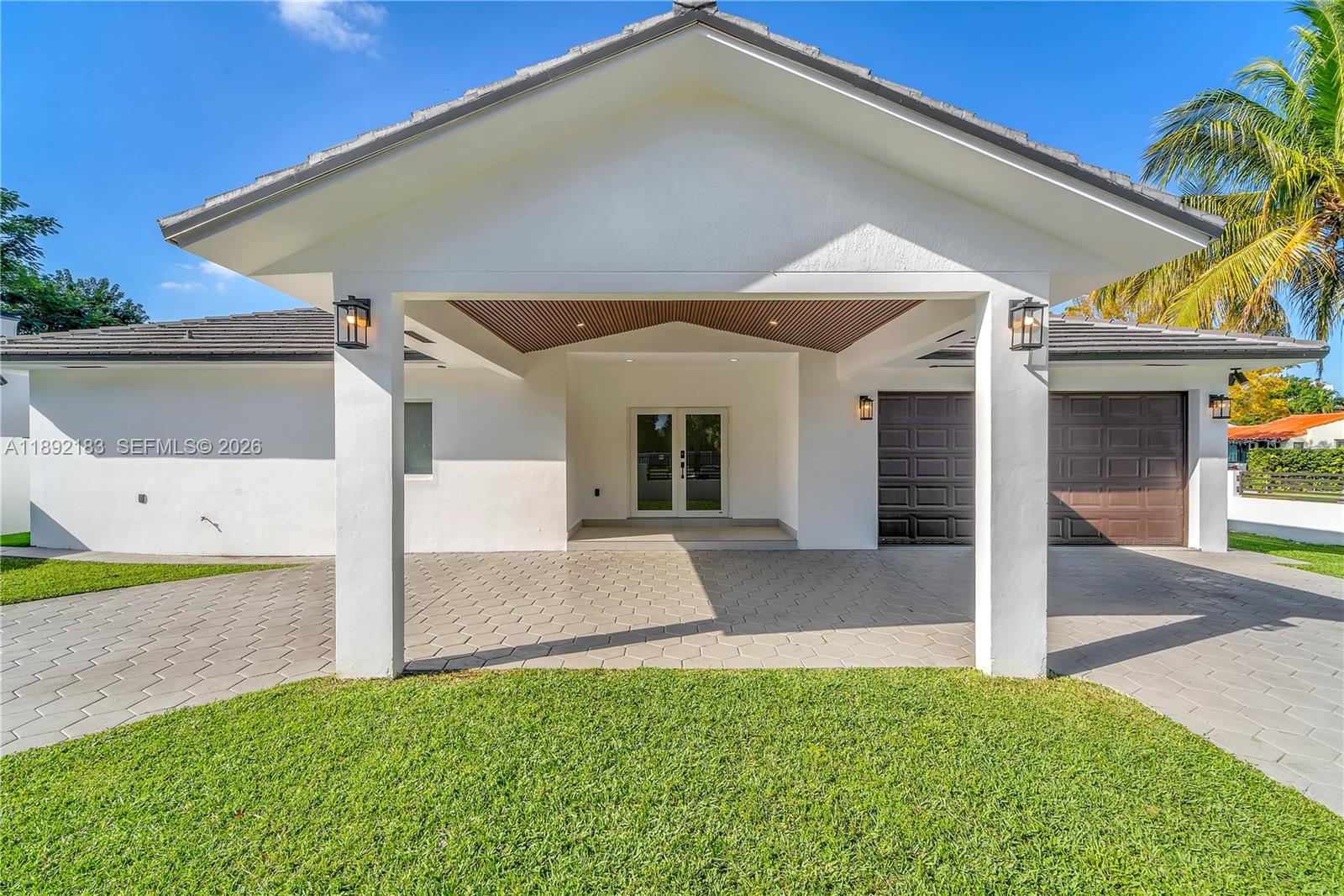 1200 Southwest 23rd Court Miami, FL 33135 - Photo 2 of 36 a front view of a house with a yard