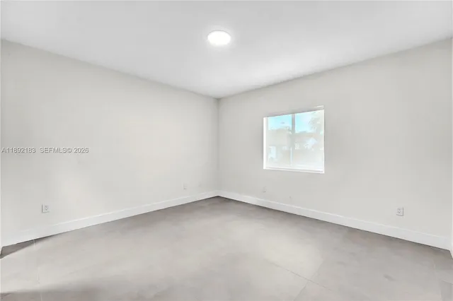 a front view of house with a garden