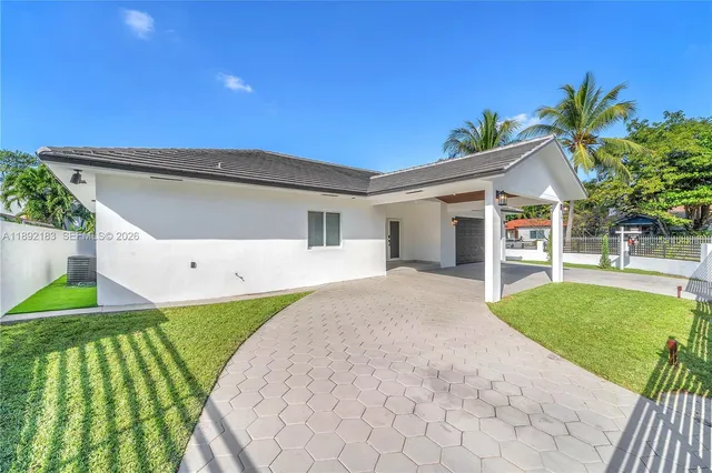 a front view of house with yard and green space