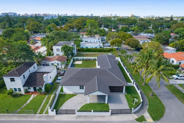 an aerial view of multiple houses with yard