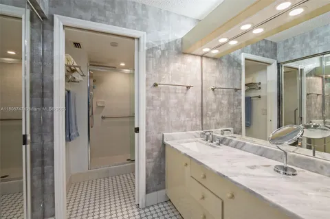 a bathroom with a shower sink and mirror