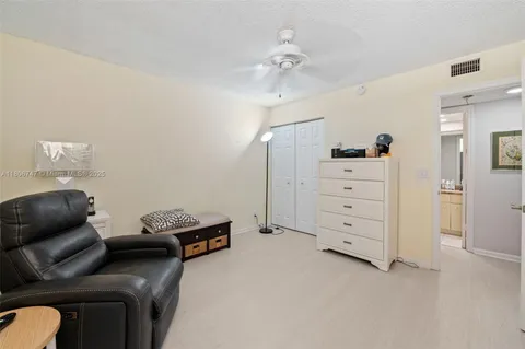 a view of a livingroom with furniture and closet