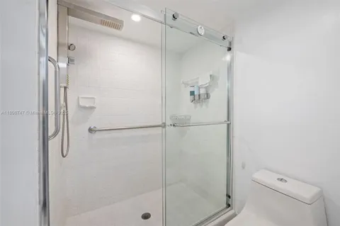 a bathroom with a shower and toilet