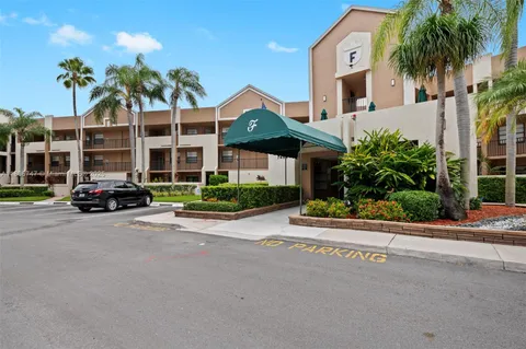 a front view of multiple houses with yard