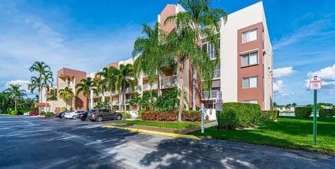 a view of tall buildings with a yard