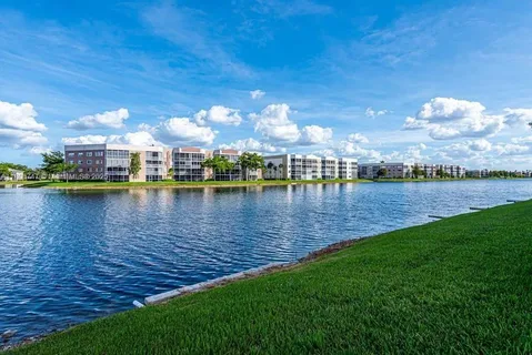 a view of a lake with houses in the back