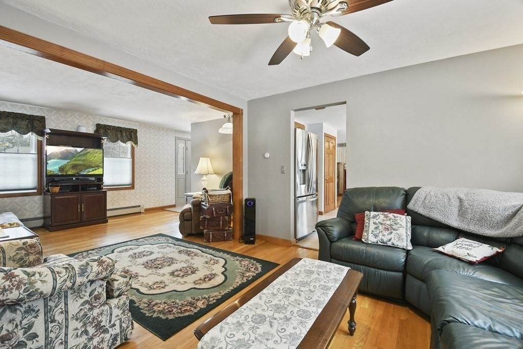 21 Merrill Road Sutton, MA 01590 - Photo 12 of 36 a living room with furniture and a wooden floor