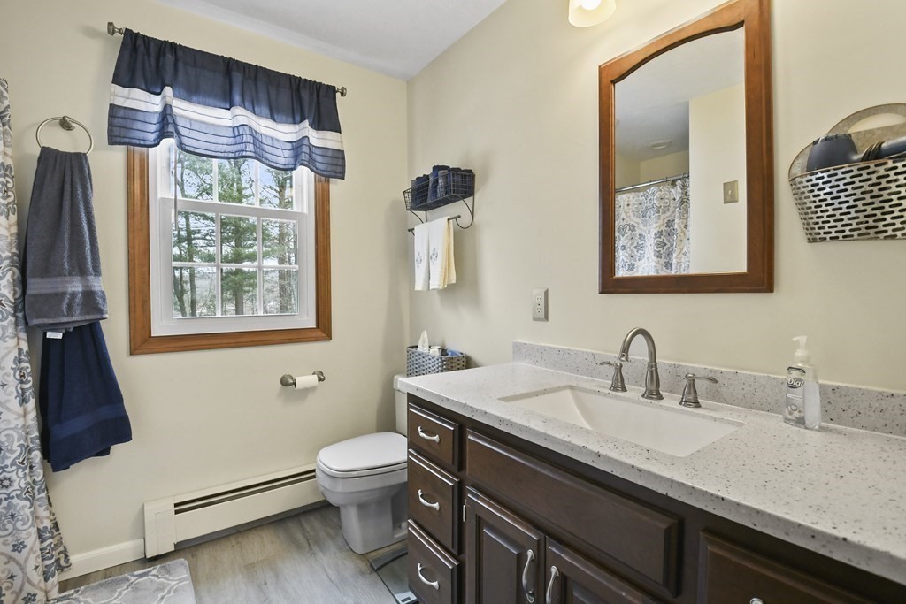 21 Merrill Road Sutton, MA 01590 - Photo 17 of 36 a bathroom with a granite countertop sink a toilet and a mirror