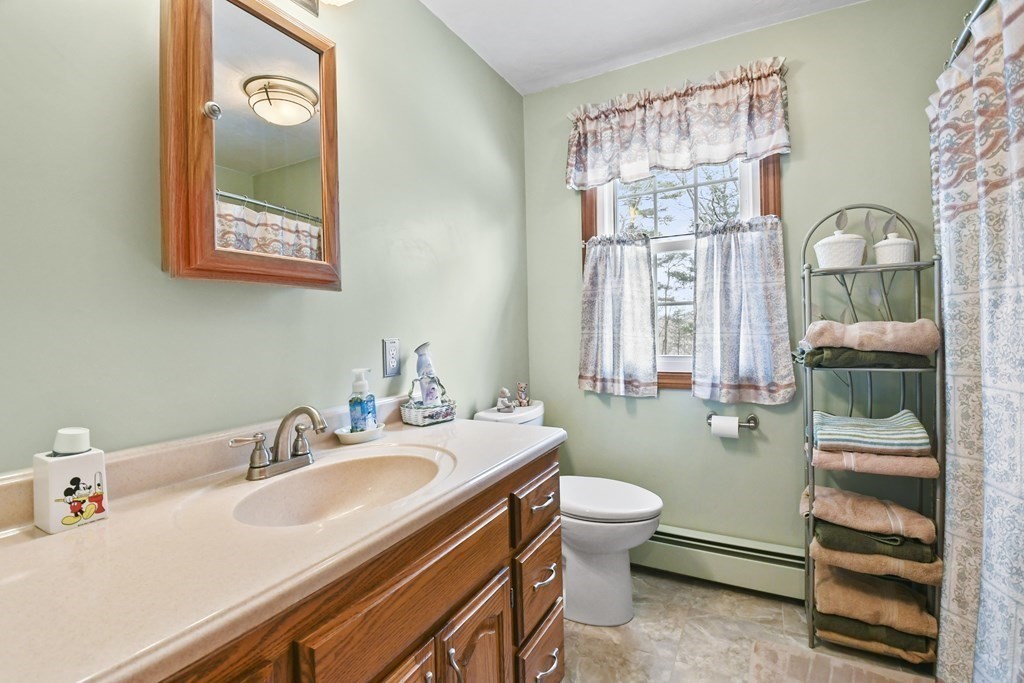 21 Merrill Road Sutton, MA 01590 - Photo 21 of 36 a bathroom with a sink a toilet and a window